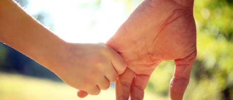 Child holding adults hand