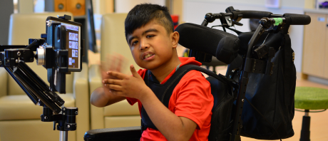 A respite worker supports a client with a craft.