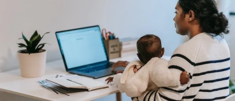 A mother with her baby on her laptop