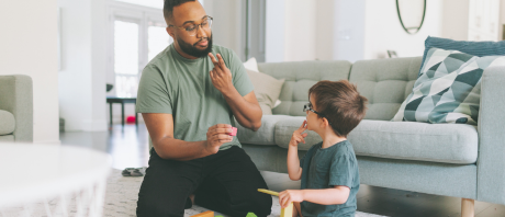 An adult and young child communicate using sign language