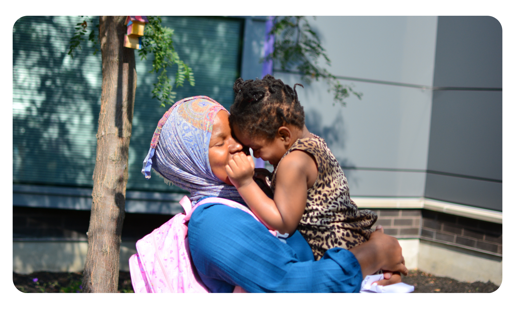 An ErinoakKids mom holding her toddler