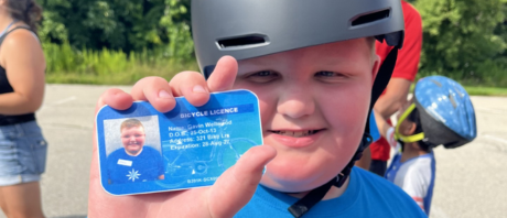 Gavin holds out his bicycle license