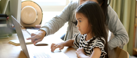 Young girl with mom on laptop
