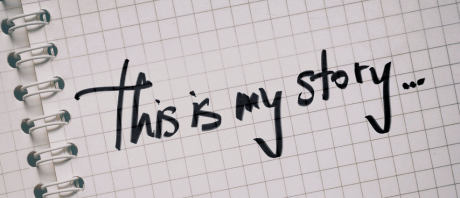 "This is my story" written on a graph paper spiral notebook
